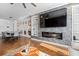 Bright living room and dining area featuring wood floors and a modern fireplace at 160 Vanira Se Ave # A, Atlanta, GA 30315