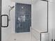 This modern shower is encased in glass and features dark tiling and a built in bench at 160 Vanira Se Ave # A, Atlanta, GA 30315