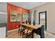 Bright dining area with wood table and orange accent wall at 447 Payne Dr, Mcdonough, GA 30294