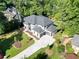 Luxury home with gray roof and white and gray exterior, surrounded by lush greenery at 4840 Northway Dr, Atlanta, GA 30342