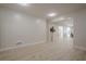 Bright, open basement with light wood floors and access to other rooms at 4840 Northway Dr, Atlanta, GA 30342