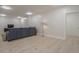 Spacious finished basement with light wood floors, comfortable seating area, and plenty of natural light at 4840 Northway Dr, Atlanta, GA 30342