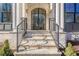 Elegant entryway with a metal framed arched glass door and stone steps at 4840 Northway Dr, Atlanta, GA 30342