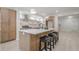 Modern kitchen with light wood cabinets, quartz countertops and island with seating at 4840 Northway Dr, Atlanta, GA 30342