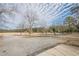 Open park area with gravel parking and mature trees at 4840 Northway Dr, Atlanta, GA 30342