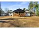 White house with black accents, wooden deck, and large backyard at 5035 Villa Rica Hwy, Dallas, GA 30157