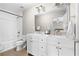 Bathroom boasts double vanity, white cabinets, and subway tile shower/tub combo at 698 Rochelle Sw Dr, Atlanta, GA 30310