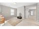 Bright bonus room with neutral walls and carpet, featuring a window and access to other rooms at 698 Rochelle Sw Dr, Atlanta, GA 30310