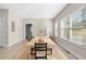 Sunlit dining area with hardwood floors and a large wooden dining table at 698 Rochelle Sw Dr, Atlanta, GA 30310