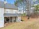 Private backyard of a townhome, with a wooden deck and surrounding trees at 900 Tree Creek Blvd, Lawrenceville, GA 30043