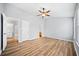 Main bedroom with wood-look floors, ceiling fan, and access to laundry and bathroom at 900 Tree Creek Blvd, Lawrenceville, GA 30043