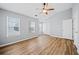 Spacious main bedroom with wood-look floors, ceiling fan and multiple windows at 900 Tree Creek Blvd, Lawrenceville, GA 30043