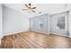 Spacious bedroom featuring wood-look floors, ceiling fan, and multiple windows at 900 Tree Creek Blvd, Lawrenceville, GA 30043