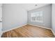 Bright bedroom with window and wood-look floors at 900 Tree Creek Blvd, Lawrenceville, GA 30043