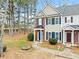 Two-story townhome with brick and siding exterior, featuring a front porch and landscaping at 900 Tree Creek Blvd, Lawrenceville, GA 30043