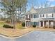 Two-story townhome with brick and siding, showcasing a walkway and parking area at 900 Tree Creek Blvd, Lawrenceville, GA 30043