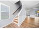 Light-filled entryway with staircase, hardwood floors, and view of living area at 900 Tree Creek Blvd, Lawrenceville, GA 30043