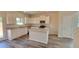 Modern kitchen with white cabinets, granite countertops, and an island at 18 Loth Wages (Lot 18) Rd, Dacula, GA 30019