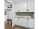 Bright laundry room with white cabinets and quartz countertops at 2359 Melinda Ne Dr, Atlanta, GA 30345