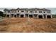 New townhomes under construction with exposed framing and building materials at 2808 Lillian Ln, Douglasville, GA 30135