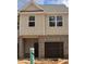 New construction townhouse with brick and board and batten and an attached garage at 2808 Lillian Ln, Douglasville, GA 30135