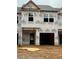 Unfinished townhome exterior showing exposed framing and Kingspan GreenGuard weather-resistant barrier at 2808 Lillian Ln, Douglasville, GA 30135