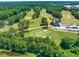 Aerial view of a lush golf course with tree-lined fairways and a clubhouse at 2808 Lillian Ln, Douglasville, GA 30135
