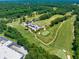Aerial view of a meticulously maintained golf course with lush fairways and a modern clubhouse at 2808 Lillian Ln, Douglasville, GA 30135