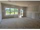 Unfinished open living room with large windows and glass door awaits your personal touch at 2808 Lillian Ln, Douglasville, GA 30135
