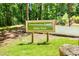 Sweetwater Creek State Park sign surrounded by green lawns and trees, inviting nature lovers to explore the park at 2808 Lillian Ln, Douglasville, GA 30135