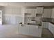 New construction kitchen with white cabinets, center island, and unfinished walls at 2816 Lillian Ln, Douglasville, GA 30135