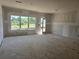 Unfinished living room with a large window and a door leading to the outside at 2816 Lillian Ln, Douglasville, GA 30135