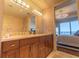 Bathroom featuring a double sink vanity and a glimpse of the bedroom with a chandelier at 3630 Peachtree Ne Rd # 2706, Atlanta, GA 30326