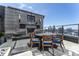 Relaxing outdoor patio with stone floors, an outdoor fireplace, TV and dining table with a city view at 3630 Peachtree Ne Rd # 2706, Atlanta, GA 30326