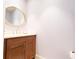 Stylish powder room with a round mirror and dark wood vanity at 3630 Peachtree Ne Rd # 2706, Atlanta, GA 30326