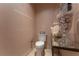 Stylish powder room featuring coral decor and light pink striped wallpaper at 3630 Peachtree Ne Rd # 2706, Atlanta, GA 30326