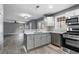 Open concept kitchen featuring stainless steel appliances and gray cabinets at 4308 Glenlake Court Northwest, Kennesaw, GA 30144