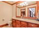 Elegant bathroom with wood cabinets, granite countertop, and a large mirror at 1401 Walcutts Nw Way, Marietta, GA 30064