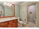 Basement bathroom with wood vanity, white toilet and shower at 1401 Walcutts Nw Way, Marietta, GA 30064