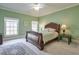 Light green bedroom with a wooden sleigh bed and a calming atmosphere at 1401 Walcutts Nw Way, Marietta, GA 30064