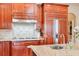 Kitchen detail showing cooktop, sink, and granite countertop at 1401 Walcutts Nw Way, Marietta, GA 30064