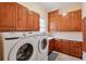 Bright laundry room with ample cabinetry and Samsung washer and dryer at 1401 Walcutts Nw Way, Marietta, GA 30064