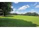 Expansive grassy field with trees and blue sky at 1401 Walcutts Nw Way, Marietta, GA 30064
