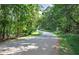 Paved road winding through lush green trees at 1401 Walcutts Nw Way, Marietta, GA 30064