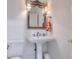 Elegant powder room with pedestal sink and ornate mirror at 1401 Walcutts Nw Way, Marietta, GA 30064