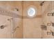 Multi-head shower with decorative tile and circular window at 1401 Walcutts Nw Way, Marietta, GA 30064