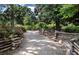 Paved walkway with split-rail fence, landscaping, and flowering bushes at 1401 Walcutts Nw Way, Marietta, GA 30064