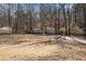 Large backyard featuring detached garage and storage shed, perfect for outdoor activities at 230 Cobblestone Ln, Mcdonough, GA 30252