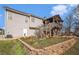Rear view of two-story home with a large deck overlooking the landscaped backyard and garden area at 230 Cobblestone Ln, Mcdonough, GA 30252