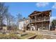 Two-story home with spacious, partially covered deck and stairs leading to the landscaped backyard at 230 Cobblestone Ln, Mcdonough, GA 30252